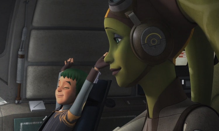 In the cockpit of the Ghost, the young green-haired Jacen Syndulla stretches in his seat while Hera Syndulla looks over from her pilot seat