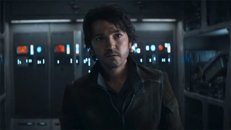 Cassian is standing in a ship with a look of acceptance on his face.