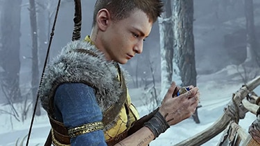 Atreus in a snowy woods holding a magic orb.