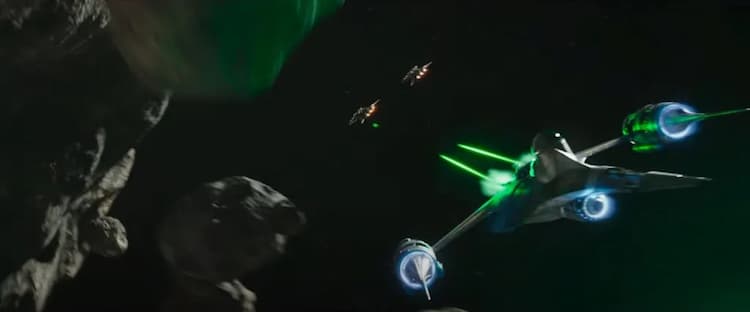 Din Djarin is in his starfighter shooting at pirates whilst flying through asteroids.