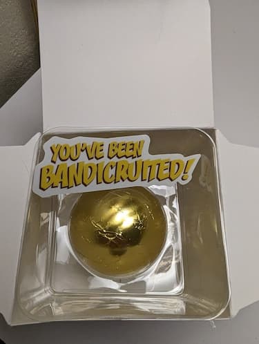 A gold chocolate sphere sits under the words "you've been Bandicruited."