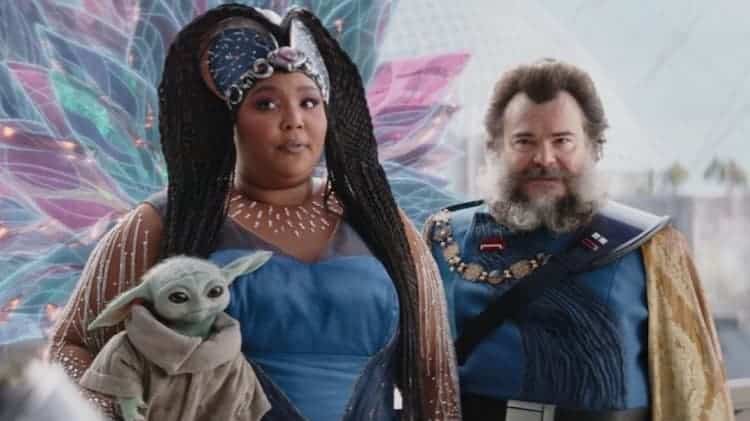 Lizzo as the Duchess holds Grogu while Jack Black as Captain Bombardier is behind them.