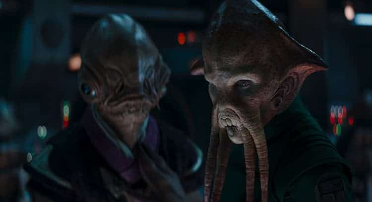 Two different species of alien fish people look longingly into each other's eyes.