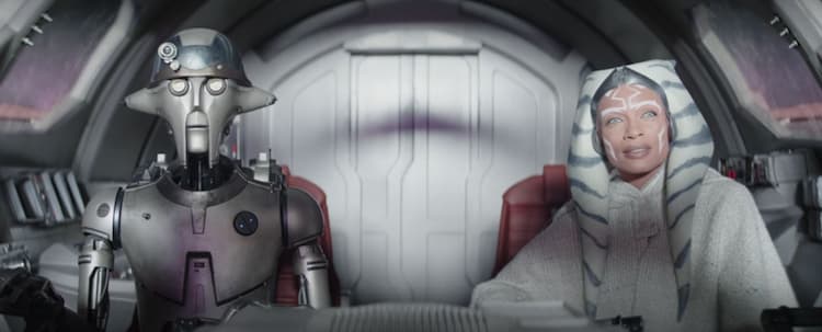 Huyang, left, and Ahsoka, right, sit in a cockpit bathed in light