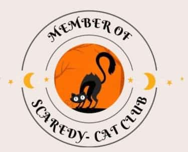 This image Is made to represent a club patch or pin. It has two circles The center smaller circle has a black cat looking scared on an orange background The outer circle says Member of The scaredy-cat Club In black fancy letters