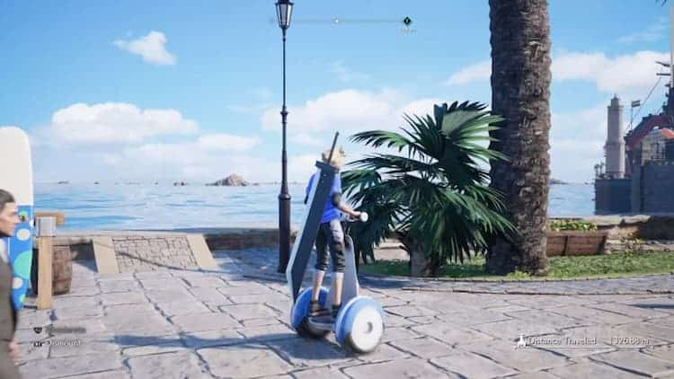 Cloud is riding a segway through a seaside town. He's wearing a blue shirt and black shorts with his sword still on his back. A person can be seen in the bottom left of the screen.
